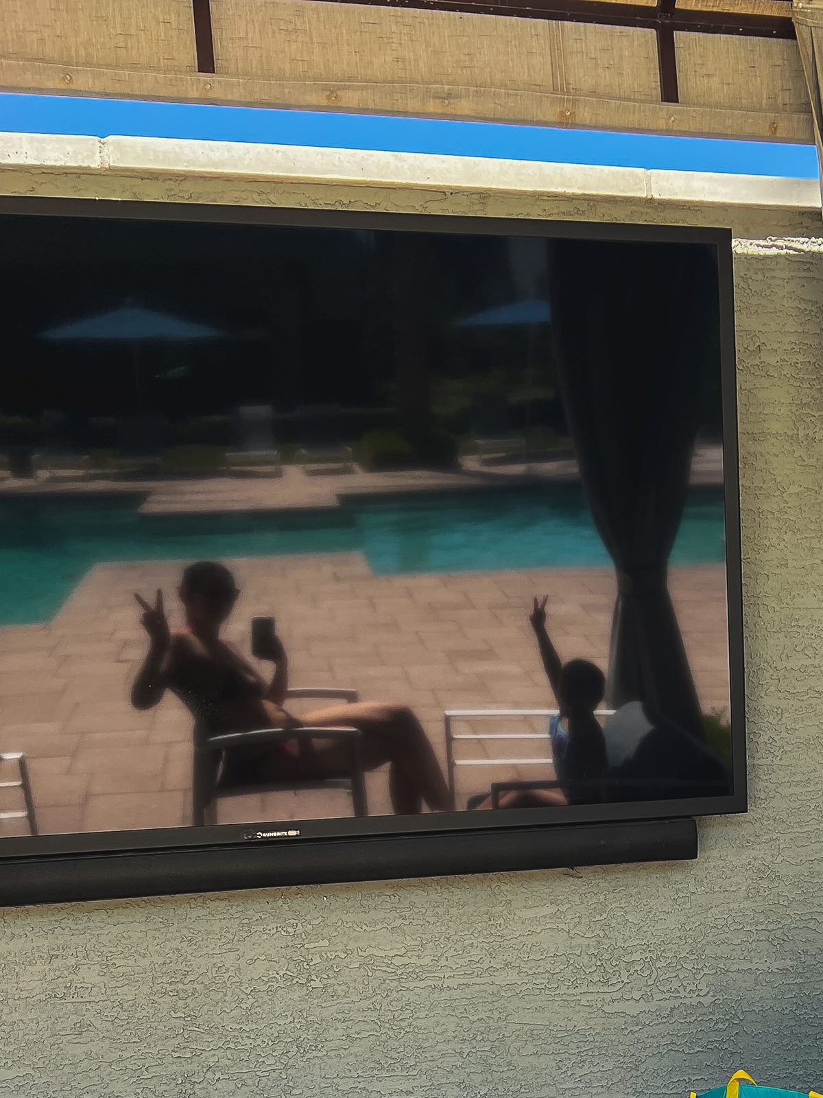 poolside with my bestie - seen in the reflection of a tv up at the pool we were at ✌
