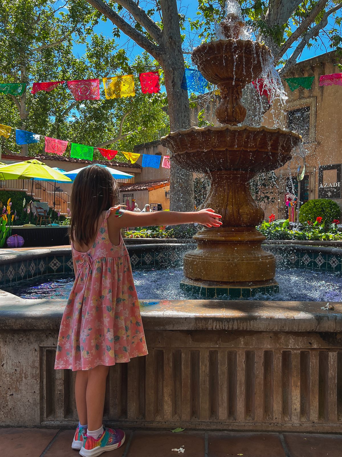 my daughter throwing coins in a fountain to make wishes in sedona