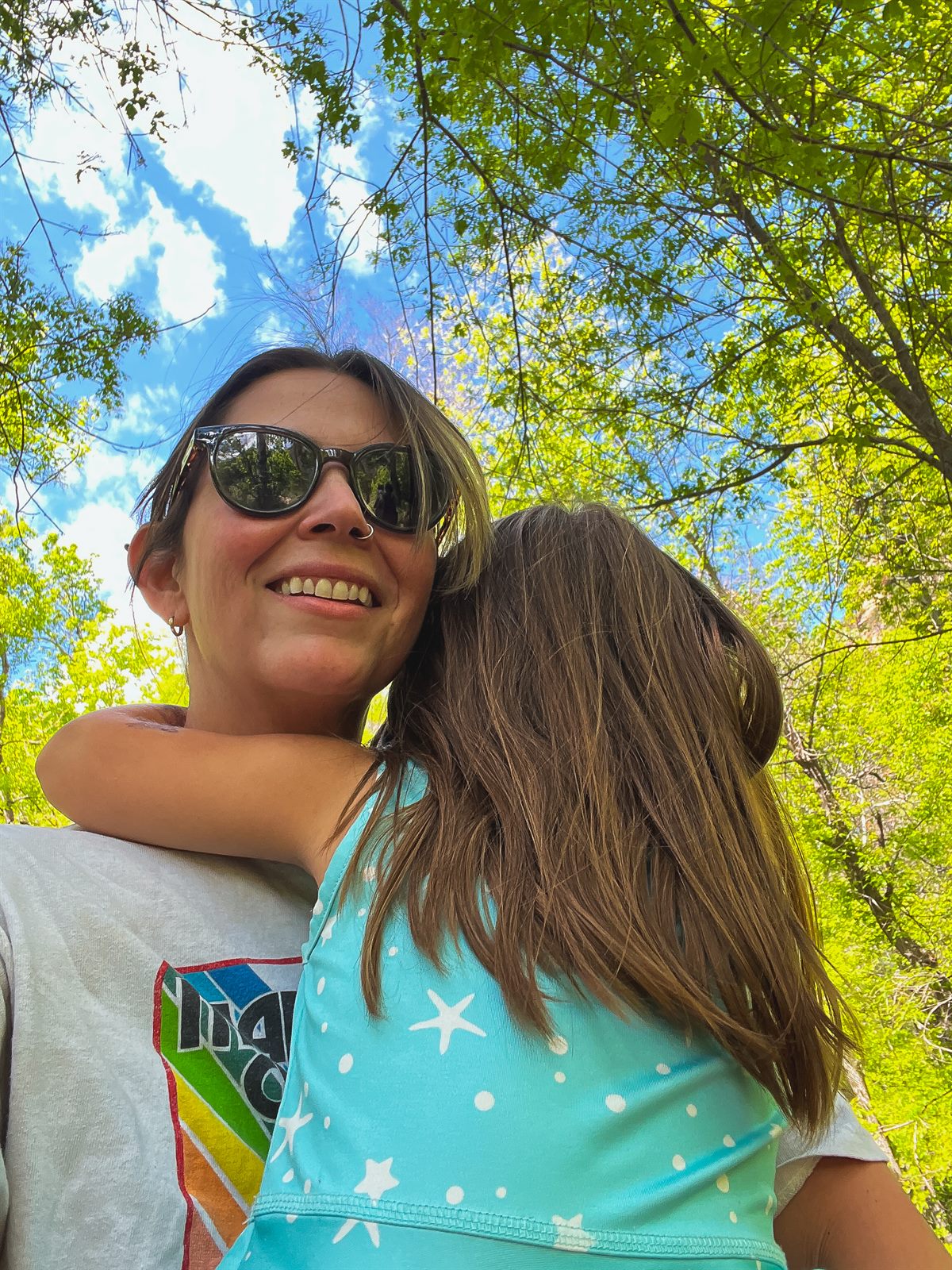 a pic of me carrying my daughter on a hike in sedona